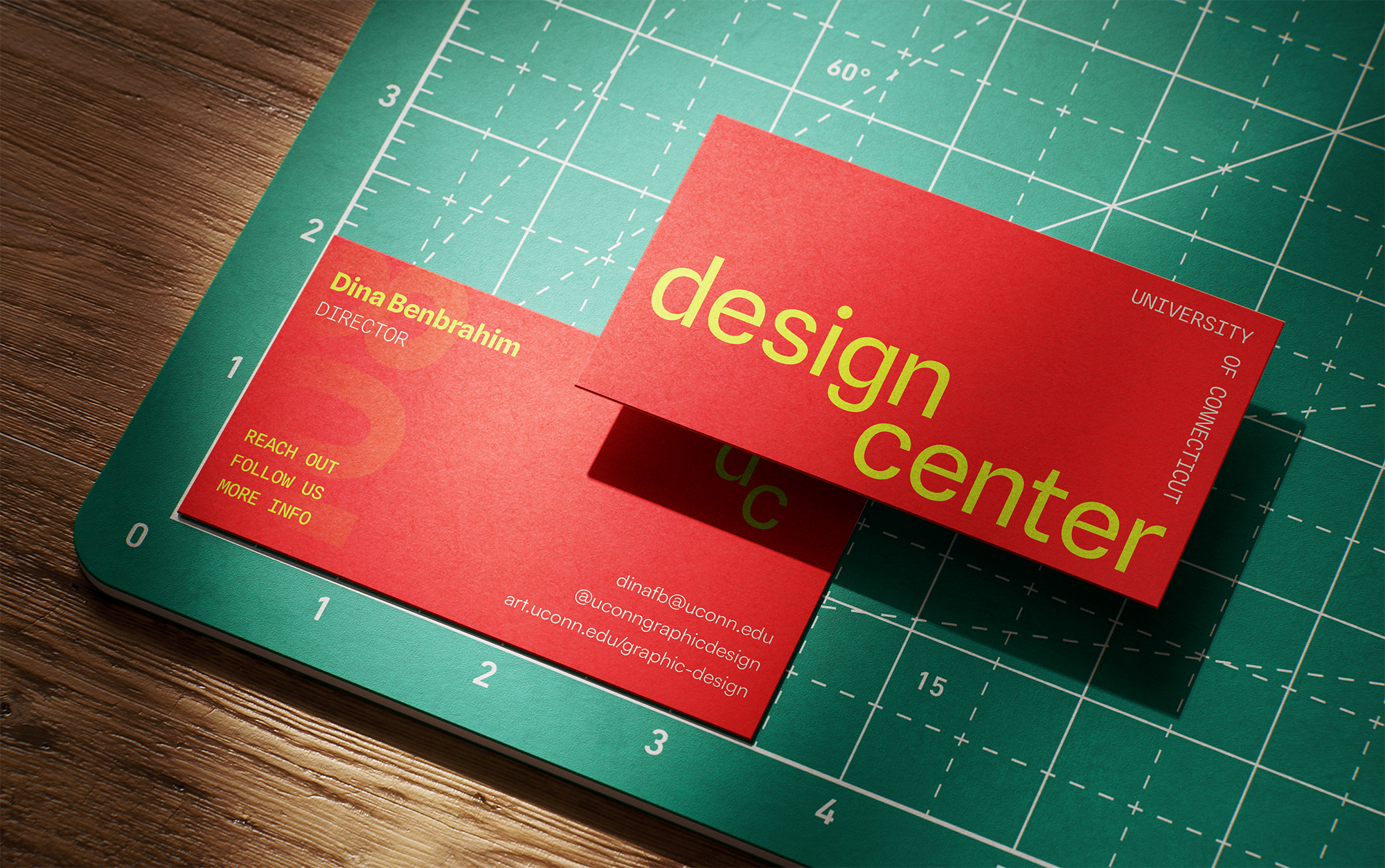 business card of design center's director, Dina Benbrahim, on a cutting mat.